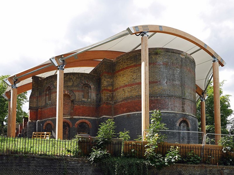 Surreal juxtaposition: Romanesque ruin meets lightweight roof.