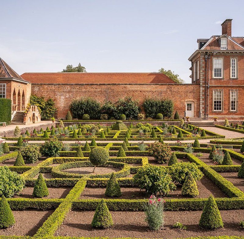 The south parterre garden. The roof peeps over the wall but defers to the Long Gallery to the west and the 17th century hall to the east.