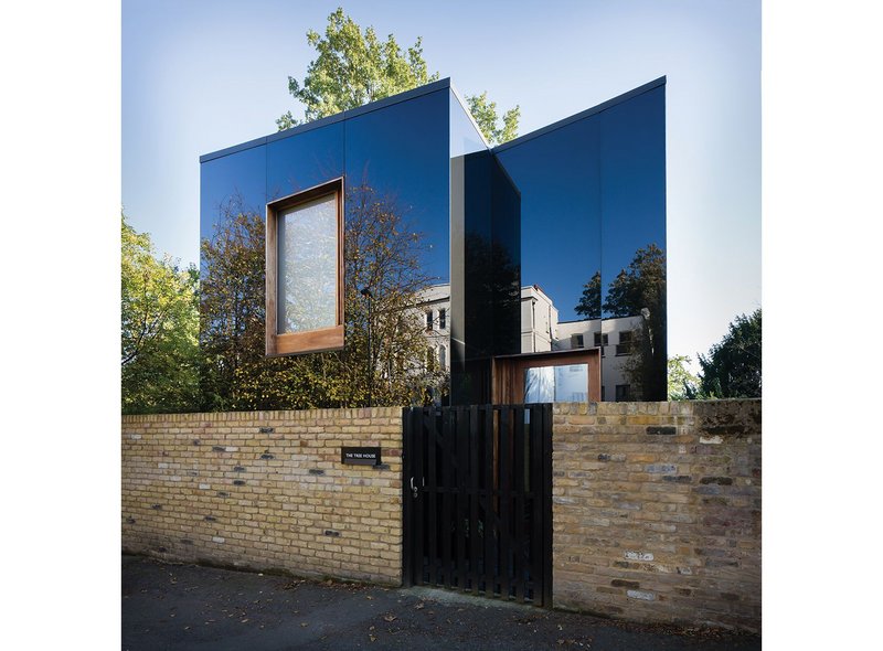 The north elevation of the Tree House with its butterfly roof form reflects the grand terrace opposite. Frosted glass in the spare bedroom window was a concession at planning.