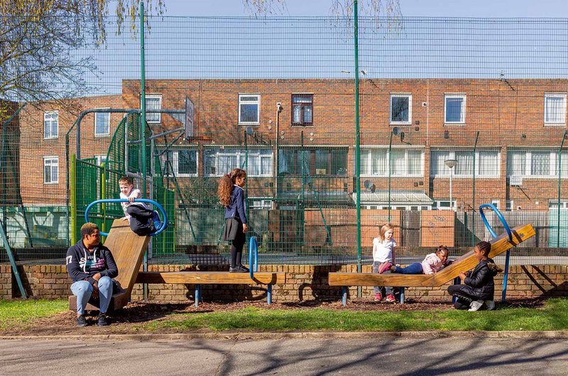 An exercise bench on Claridge Way multi-tasks as seating and playspace.