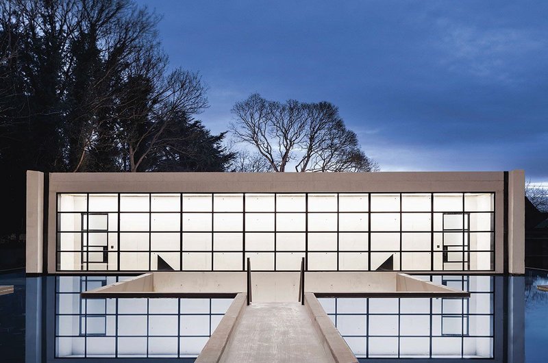 The Ghost House, so named because it is mostly below ground, is approached via a concrete walkway between two black ink-dyed pools.