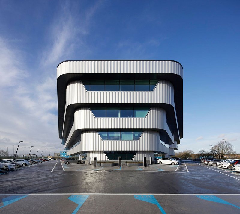 Interserve rises from a sea of cars and car parking at podium level.