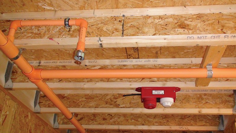 Temporary sprinkler system and smoke alarm in an all-timber multi-storey construction.