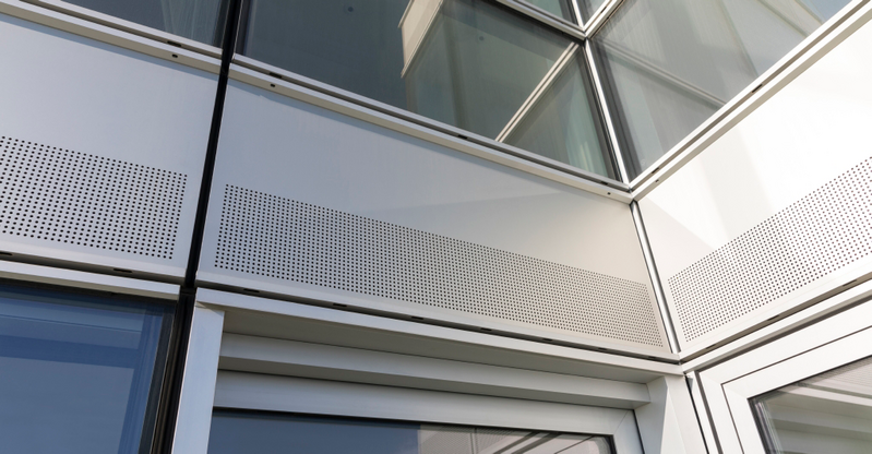 Renson Invisivent thermally broken window ventilators at Providence Tower, Isle of Dogs. The vents sit behind the perforated facade panels.