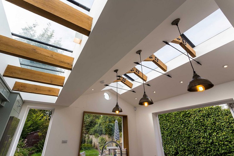 Glazing Vision's Flushglaze (left) and Ridgeglaze rooflights open up to the sky, highlighting the exposed beams and rafters below.