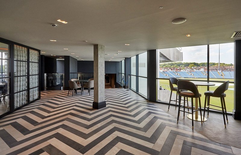 Technicolour timber-effect tiles create a character herringbone floor at Emerald Headingley Stadium.