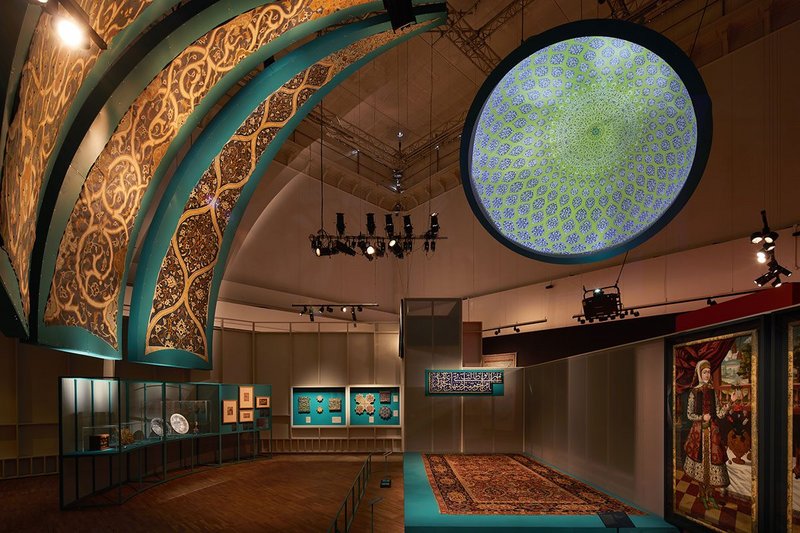 Installation view of Epic Iran, an exhibition designed by Gort Scott at the V&A, London. The sections of the exhibition are conceived as different parts of a city.