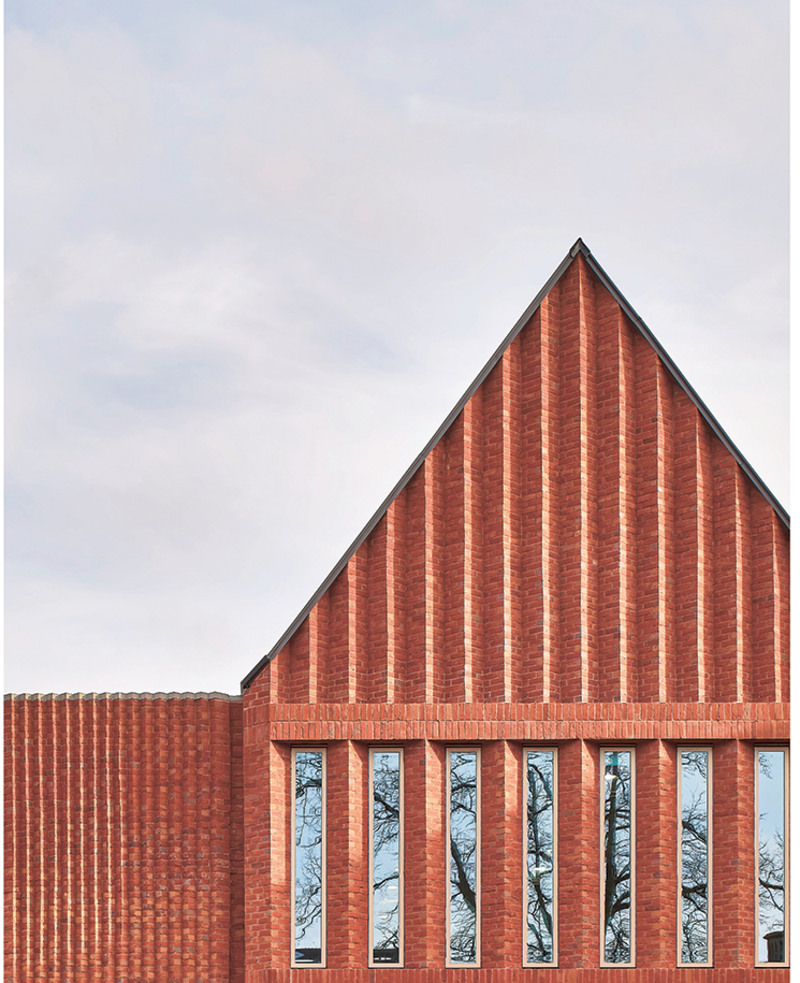 A complex thing to build, the west elevation of the new centre takes its cue from the buttressed 19th century school hall nearby.