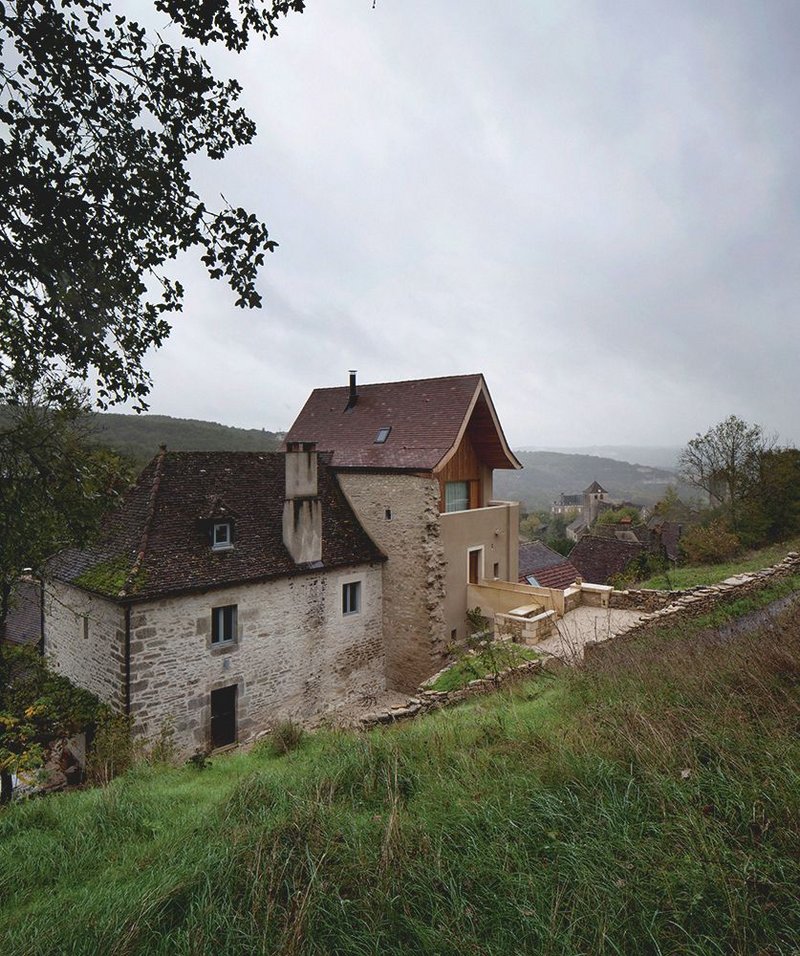 A merchant’s tower, the very visible roof has been given a traditional kick to its pitch.