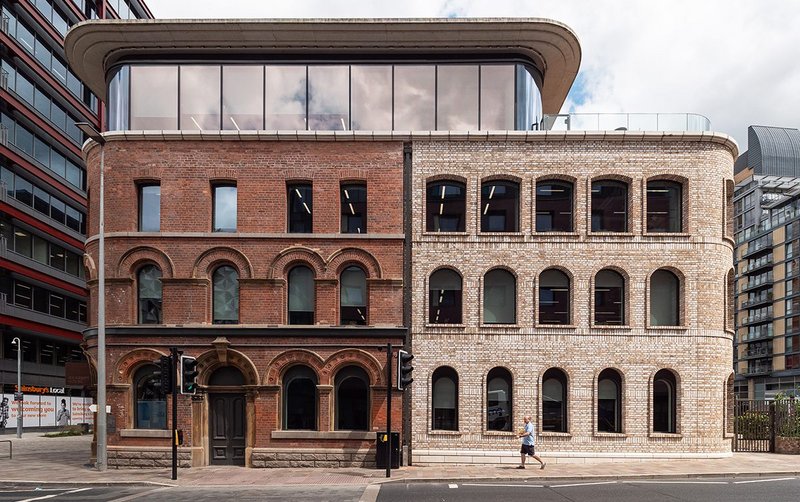 The Royal Veteran Tavern reborn as Riverside House, Salford: Restoration of the 19th-century brick facade (on the left) alongside construction of a new Category A office building (right).