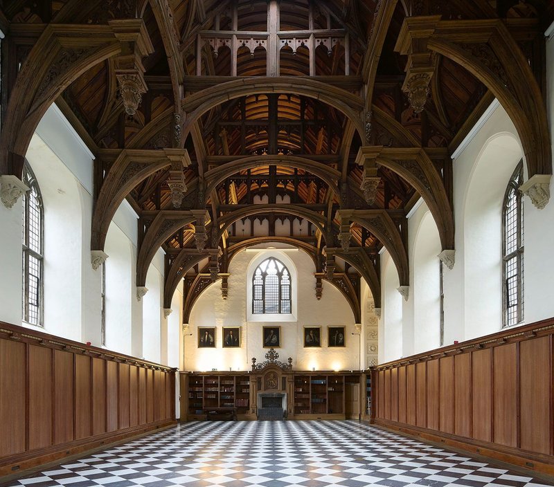 In the Great Hall, warm air from adapted trench heaters rises in front of and behind panelling made from former bookshelves.