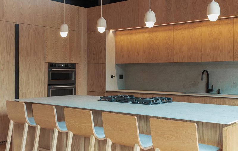 Neolith Beton worktops and splashback in the oak-lined kitchen at Casa Dos Aguas.