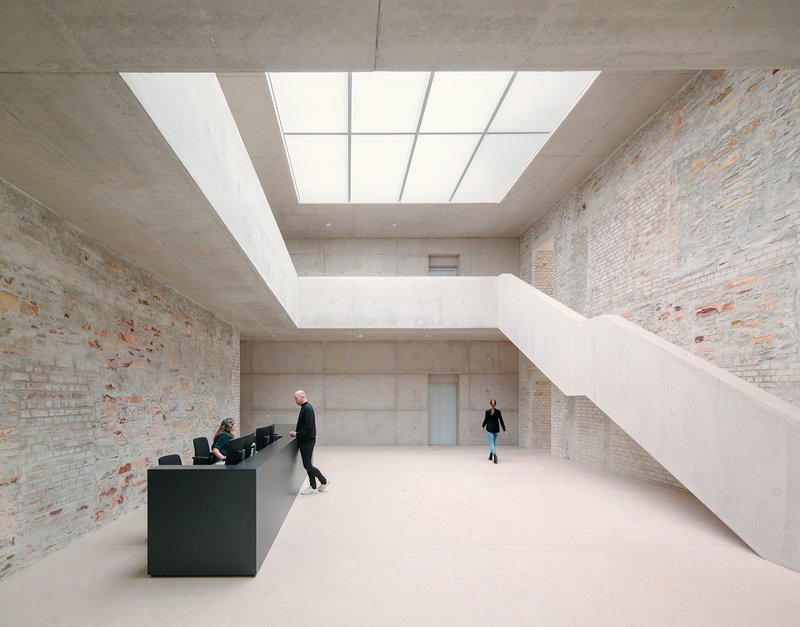 Jacoby Studios, Paderborn, Germany, by David Chipperfield Architects – the toplit entrance space pairs smooth concrete with textured old walls.