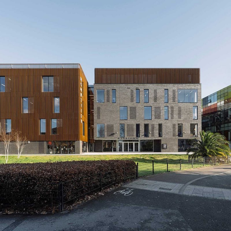 Robust materials of concrete, brick and Corten steel on the entrance elevation intimate the performance requirements of the spaces within.