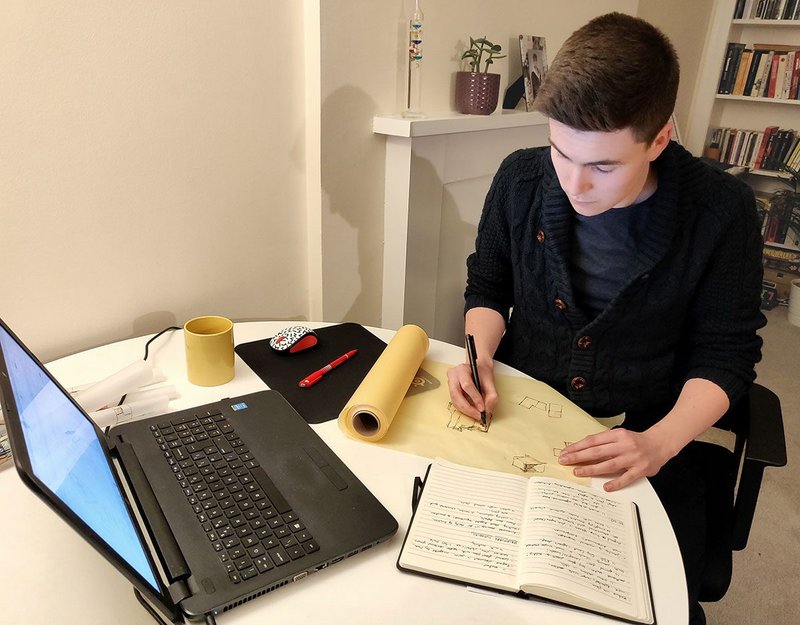 Daniel Anderson, a student at Edinburgh School of Architecture and Landscape Architecture (ESALA), prepares a sketch for a final project by hand.