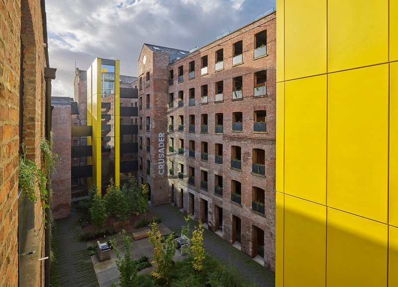 New exterior corridors at shedkm’s Crusader Works in Manchester reference the existing industrial architecture.