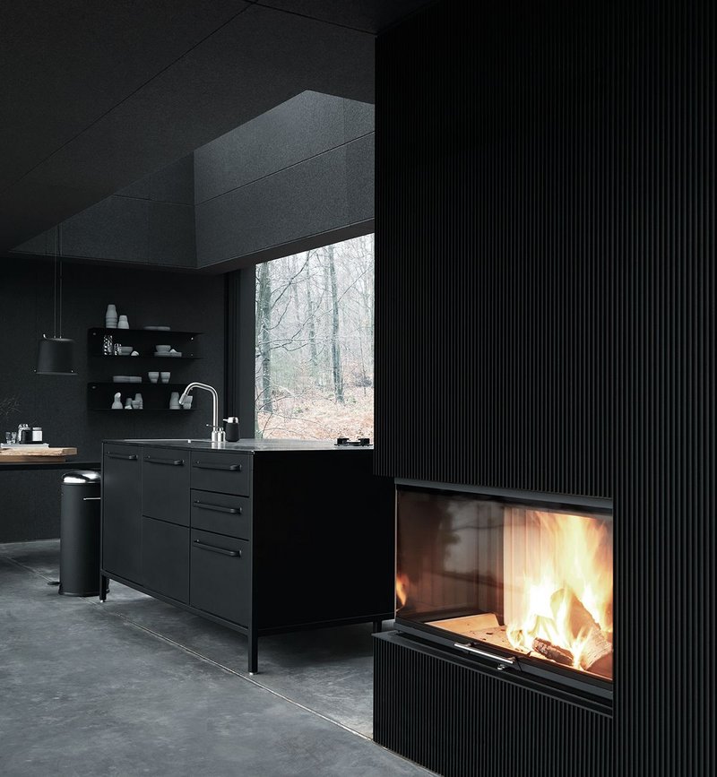 Looking towards the fireplace and kitchen area – everything forms part of a singular, branded design aesthetic.