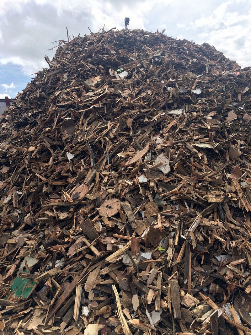 Waste wood at a recycling plant. The material is typically chipped and made into products like MDF or animal bedding, or incinerated for energy.