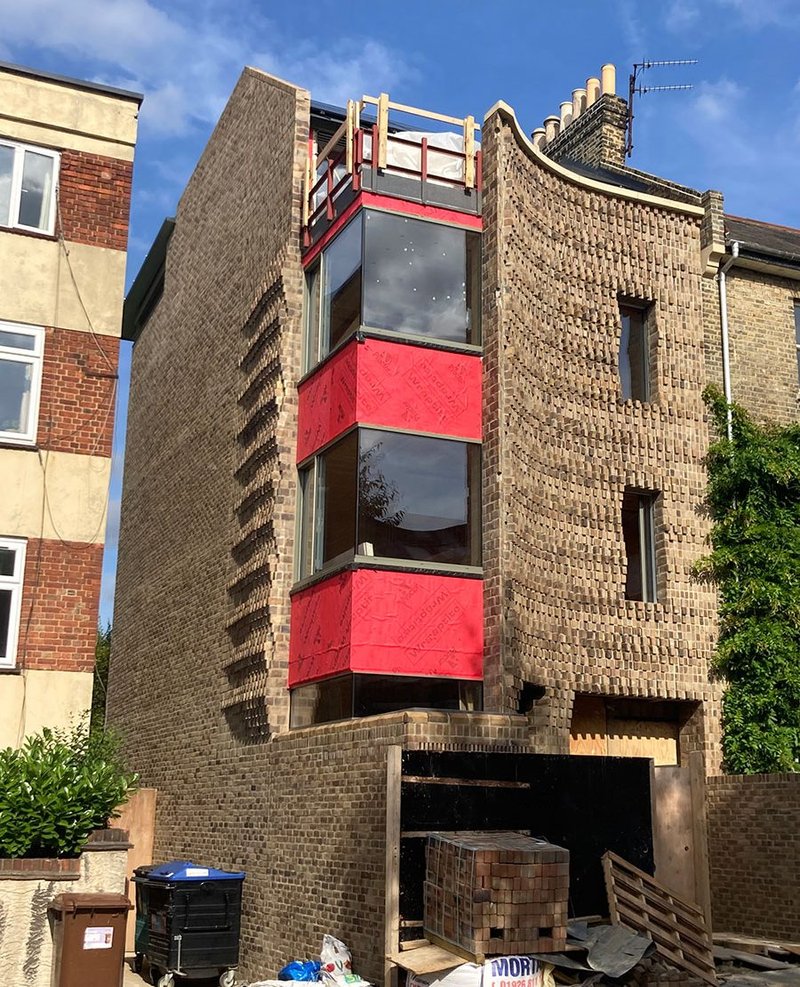 House in Peckham under construction using bricks modified by Everything Now Design.