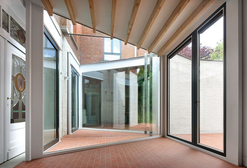 Looking west from the dining room out to the patio, the mirror wall creating the illusion of extended space.