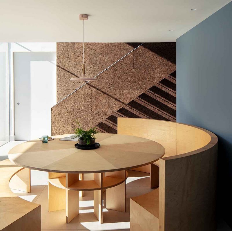 The bespoke dining table and cork clad staircase were designed by Guttfield Architecture.