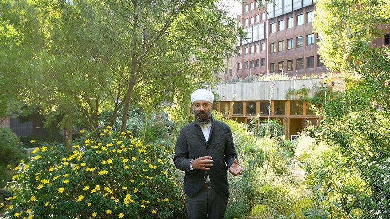 Still from the Open House film by Jim Stephenson on Phoenix Garden. Community Building, Camden, with architect Gurmeet Sian in the foreground.