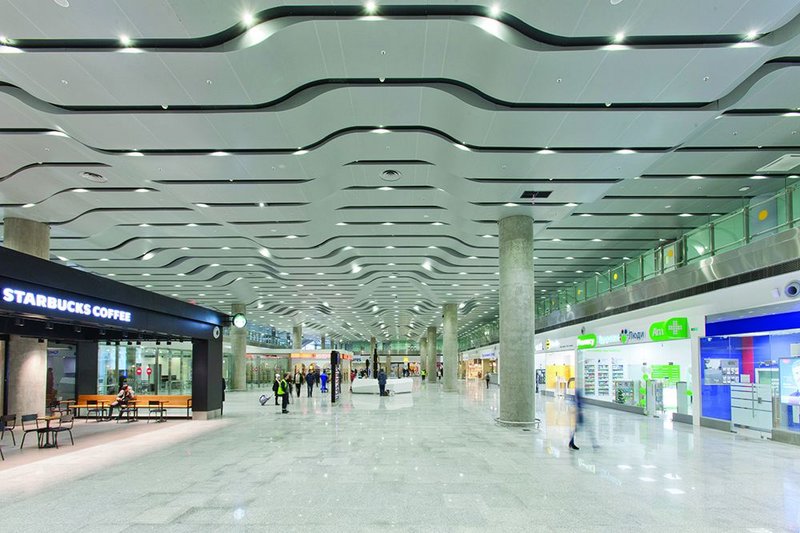 The roof beneath the roof: the arrivals hall has its own very different soffit treatment.