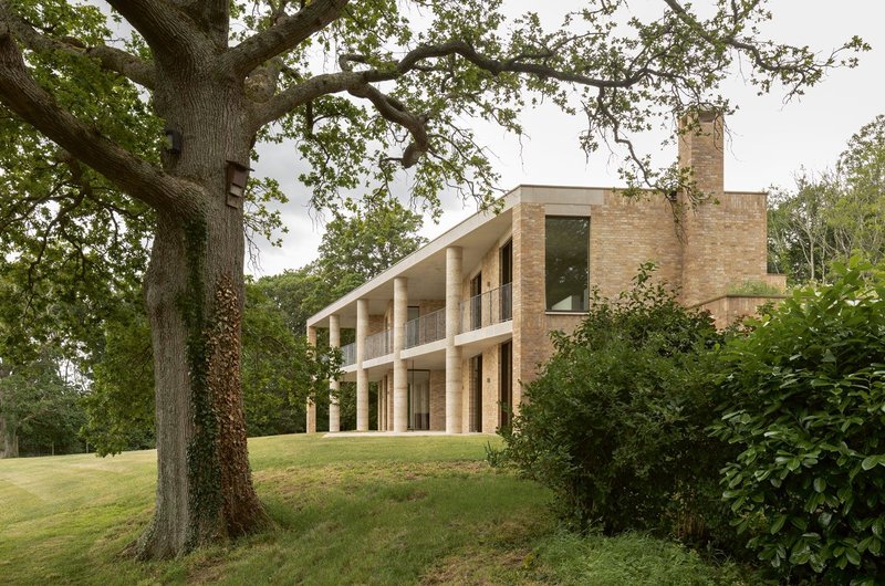 The house is positioned in the landscape as a centrepiece in a formal parkland.