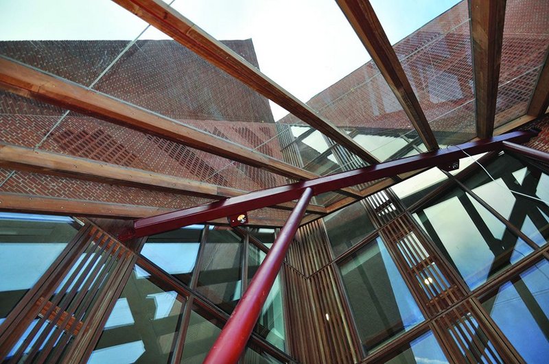 The tectonic plates of the building’s facade collide at the focus of the entrance canopy.