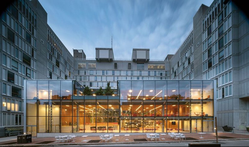 The clean lines, glass and steel of Hopkins’ Harvard Commons pavilion contrasts with the original concrete brutalism.