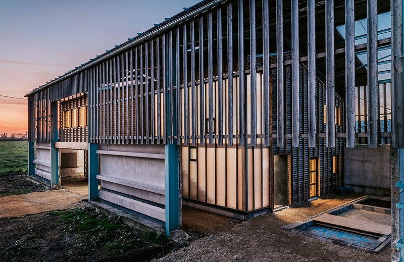 Elements of the barn are recomposed in new facades.