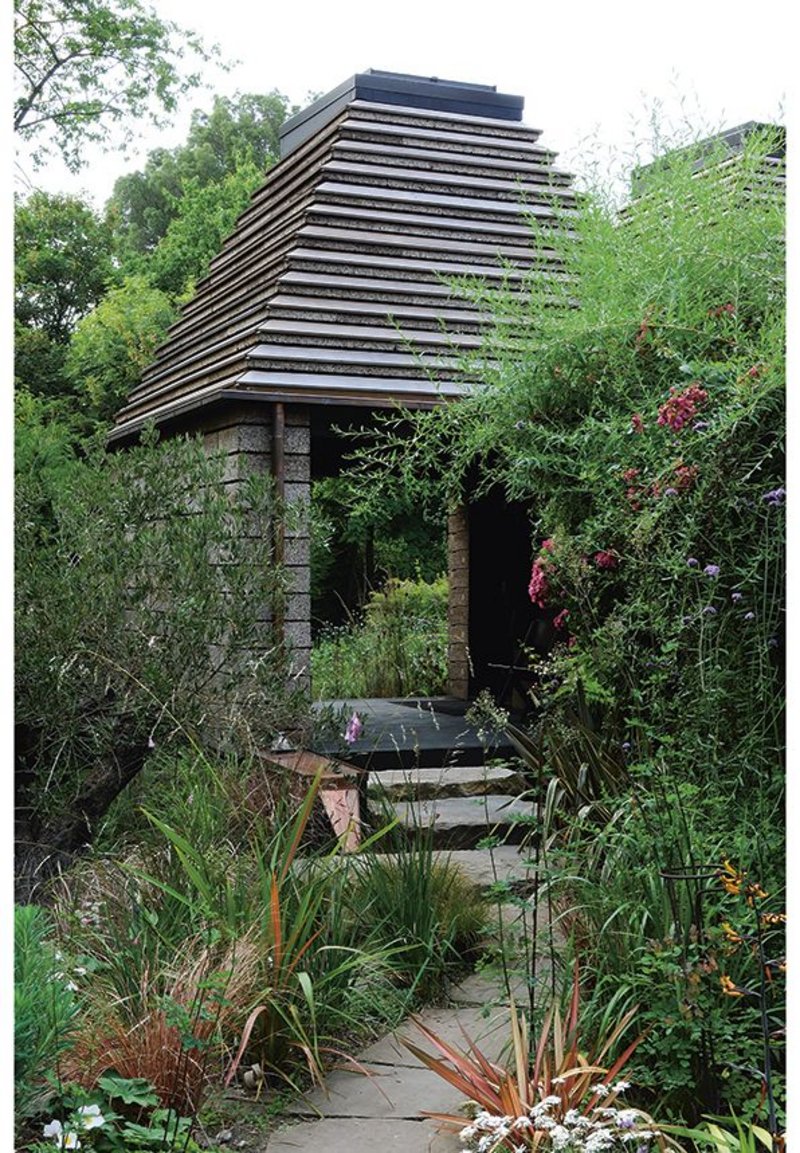 A bountiful flowering garden at the back of the main house leads to the loggia entrance to the Cork House which elegantly resolves an awkward junction between two gardens.