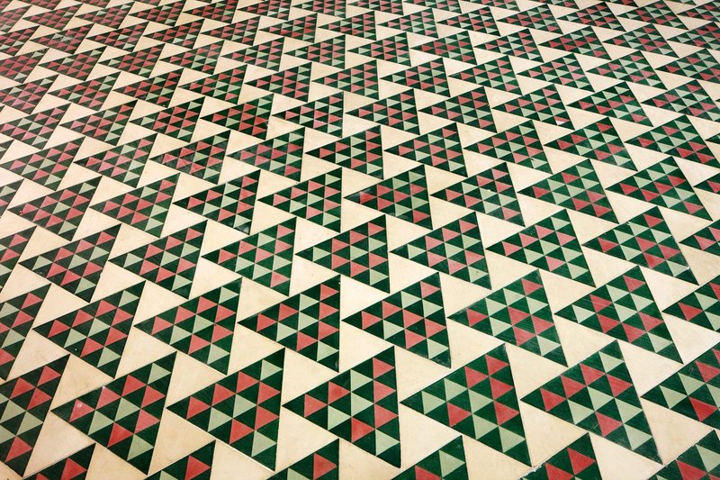 Detail of triangular-patterned floor tiling at the Carrer Avinyó apartment in Barcelona.