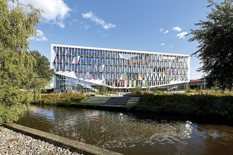 Overlooking a nearby river, the south face of the Kolding campus makes full use of its dynamic facade of triangulated panels.