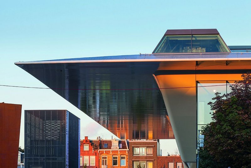 View looking west at the 12m cantilevered overhang of the south-facing facade of the museum extension. Reflections are barely disturbed, as in a canal.