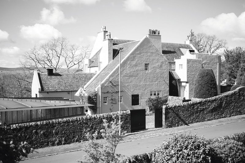 The garage, left, hunkers behind the wall at Windyhill’s Rowantreehill Rd elevation to give clear views of Mackintosh’s dovecote and catslide gable.