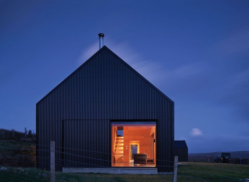 Barn-like and lit up at night.