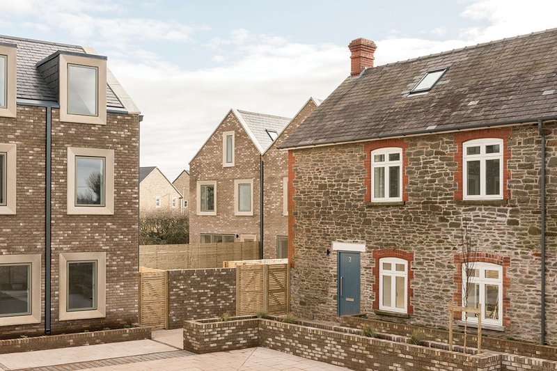 Differing plots and the layout give a sense of an older place that grew organically. Here the end of the terrace is visible (left) with the pair of larger houses behind and the converted barn