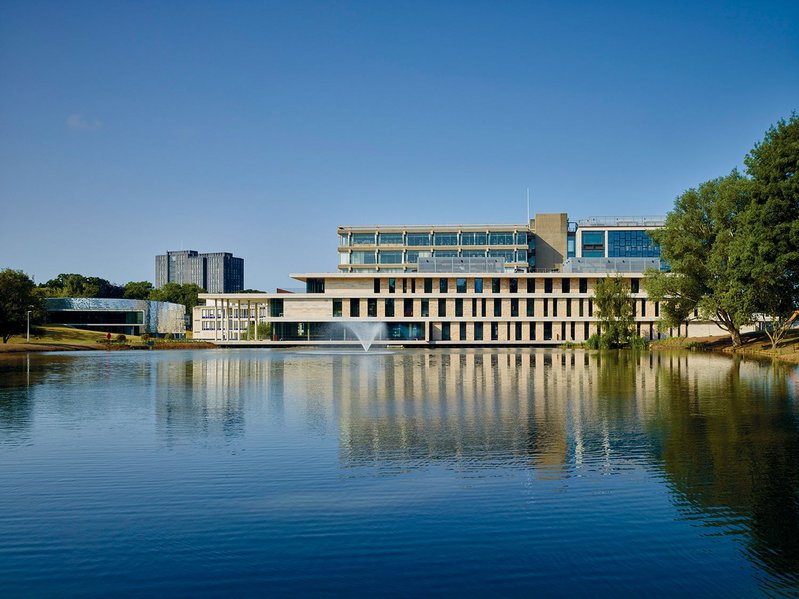 The new Silberrad Student Centre sits between the lake and the library  – the library extension is on the right.