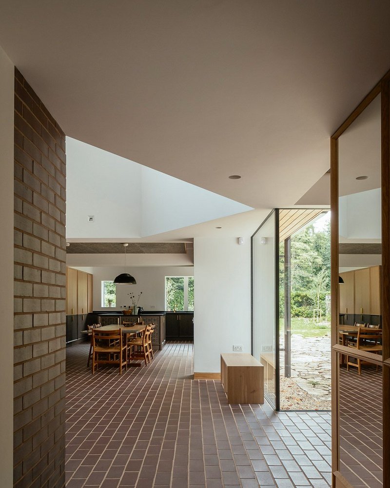 Looking through the house from the entrance – oak, brick, white walls and glass form the materials palette.