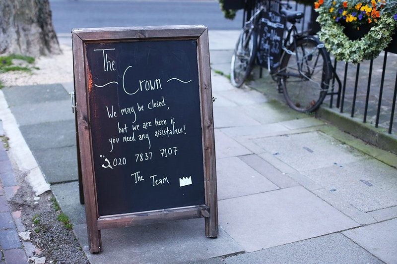 'Here if you need help' – the friendly coronavirus message from The Crown pub in north London.