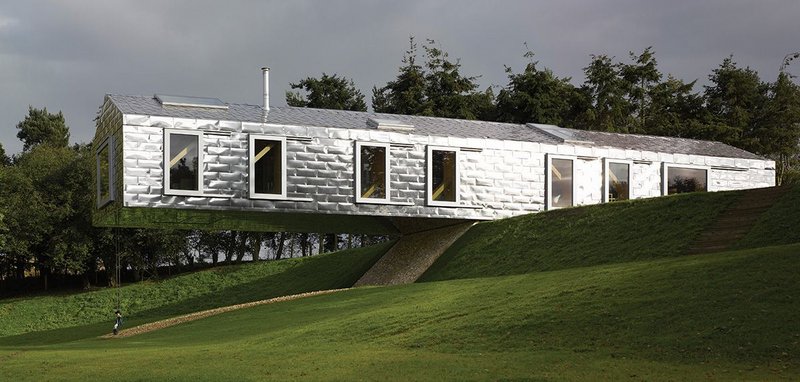 MVRDV’s stainless steel shingle clad Balancing Barn brings reflective drama to its context.