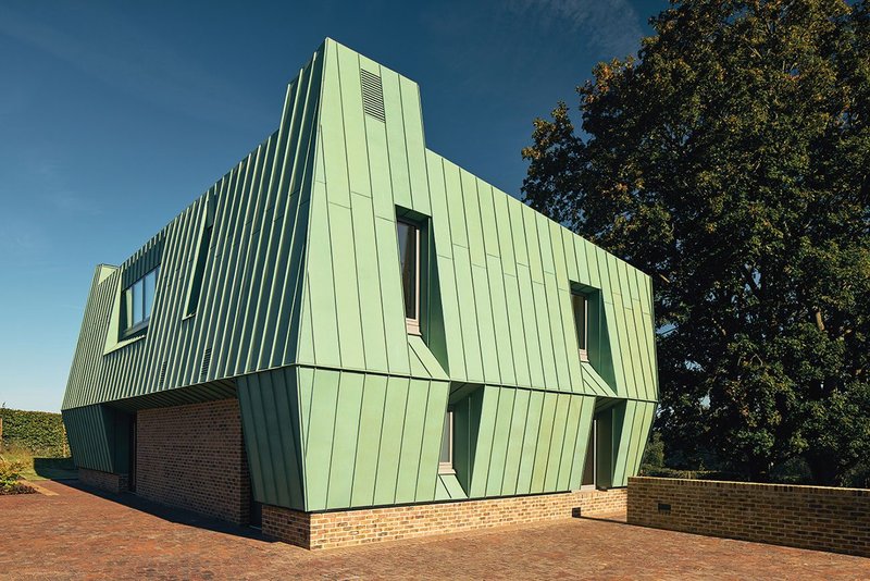The house, approaching from the access lane. The clerestory glazing above the entrance porch works for nighttime purging.