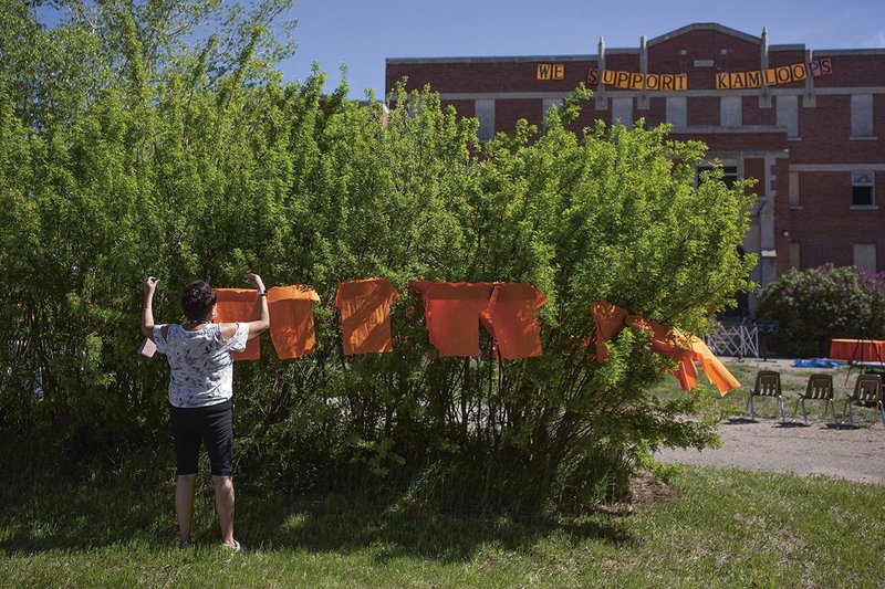 Volunteers prepare for a June 2021 press conference and prayer vigil at the former Muscowequan Indian Residential School.