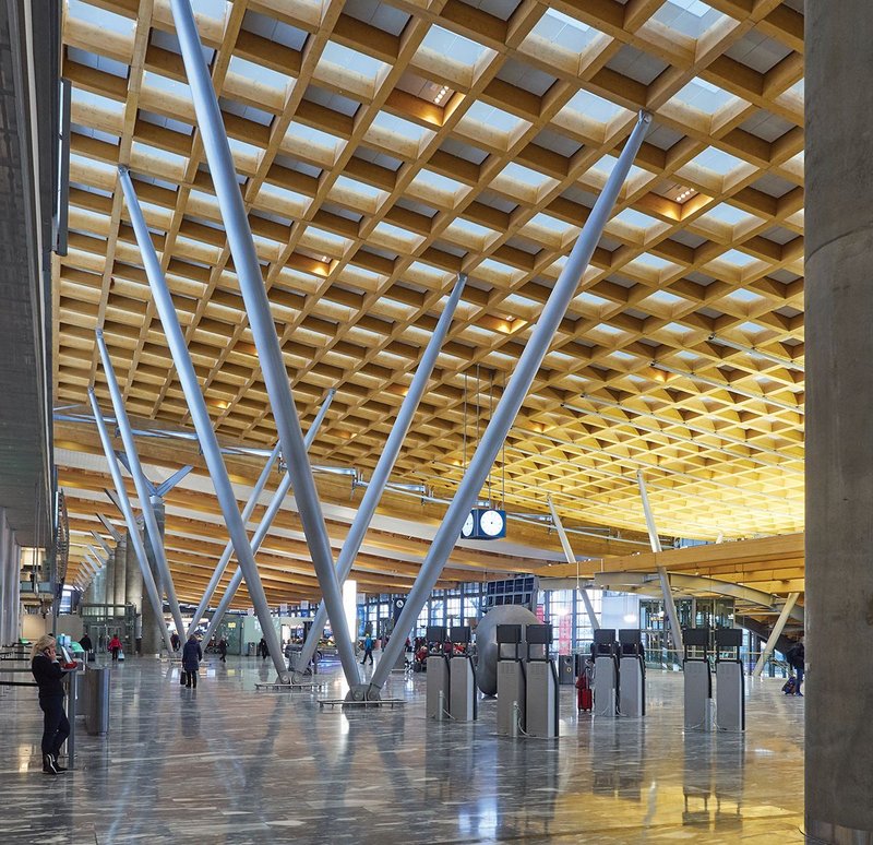 Looking along the extended departures hall, the huge glulam timber lattice roof allows daylight to pour into the terminal building.