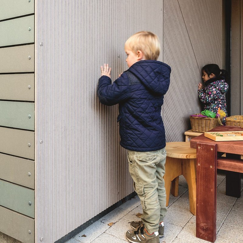 Children feeling textures at their nursery.