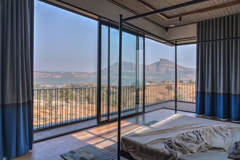 The master bedroom has uninterrupted views of the Sahyadri mountains.