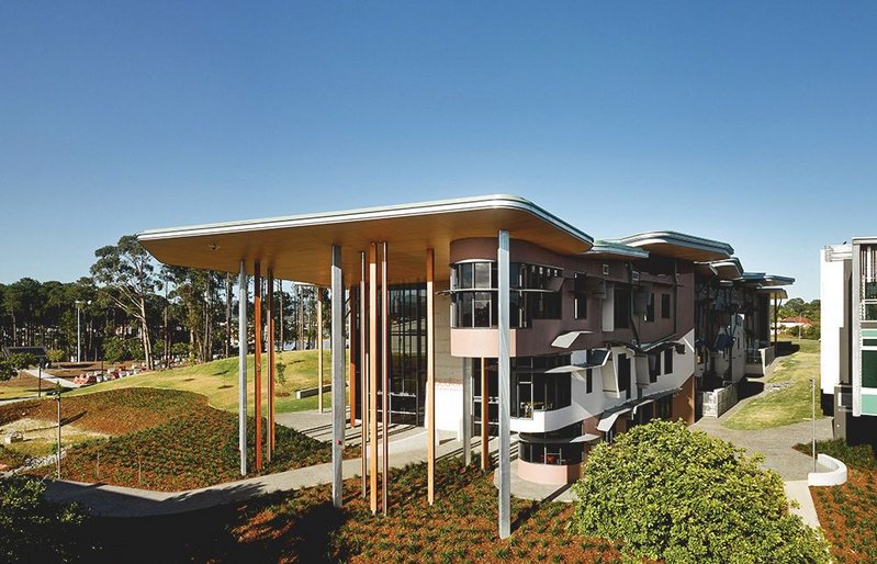 Raised eyebrows of shades to the sunny north elevation, while columns cluster alongside the ‘nose’ at the front door of the school.