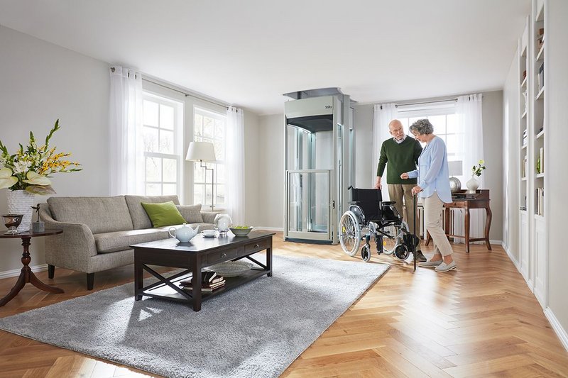 Stiltz's Trio+ Home Lift installed in a living room is suitable to carry three people or a wheelchair user.