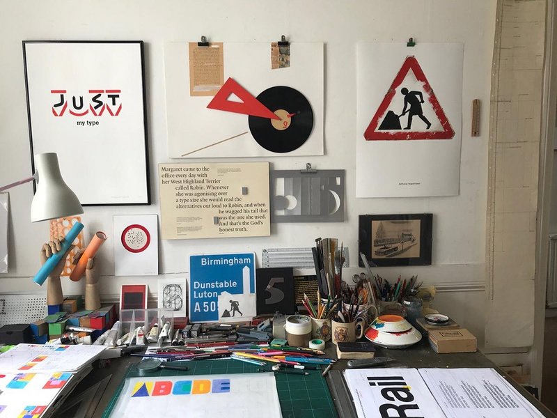 Margaret Calvert's studio from the Margaret Calvert - Woman at Work exhibition at the Design Museum. Her self portrait, a customised version of the road works sign is above right.